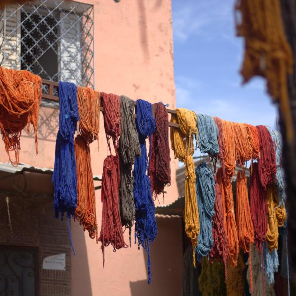 Des fils de laine colorés suspendus pour sécher selon une teinture traditionnelle.
